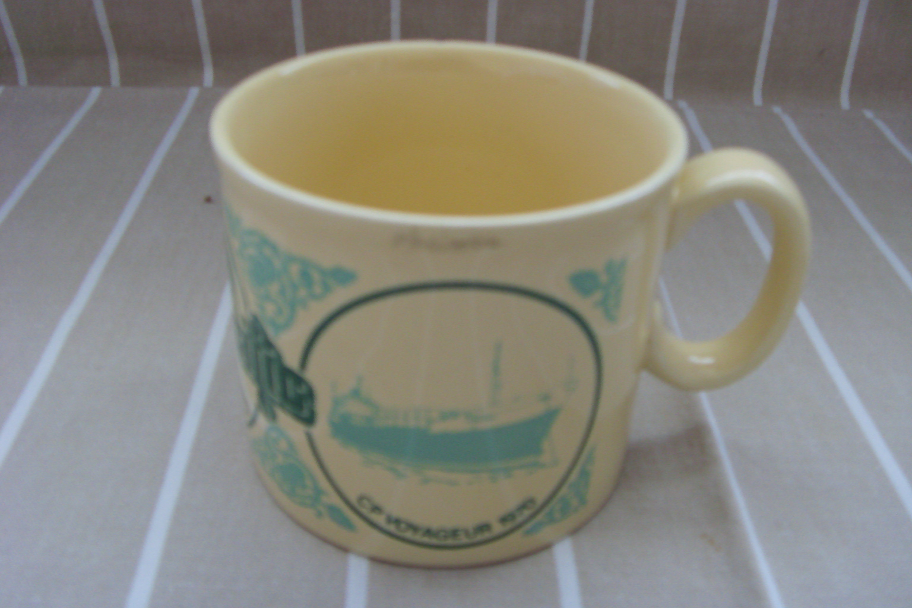 SOUVENIR MUG FROM THE VESSEL CP VOYAGEUR OF THE CANADIAN PACIFIC STEAMSHIPS COMPANY